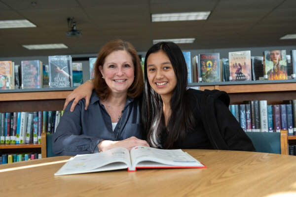 Sandy Vigen and her mentee meet in a library