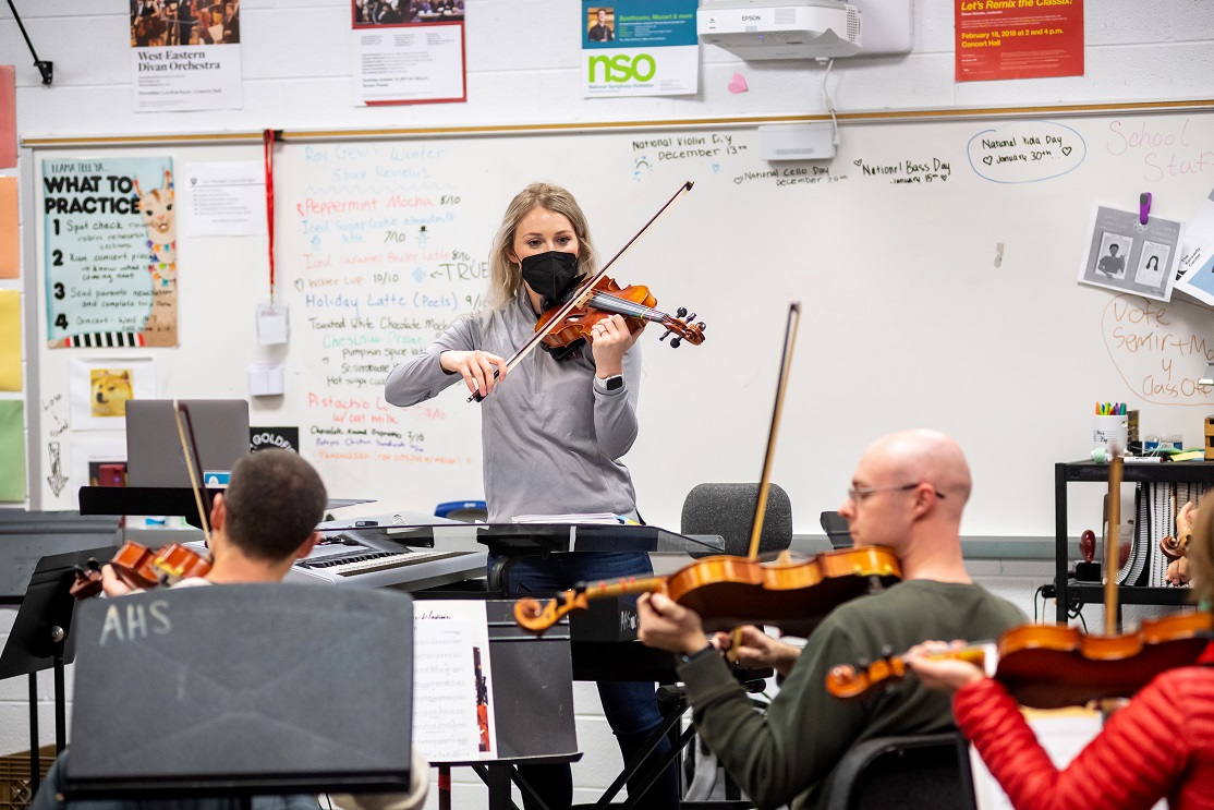 Annandale High School Orchestra Director Annie Ray leads the group during practice. 