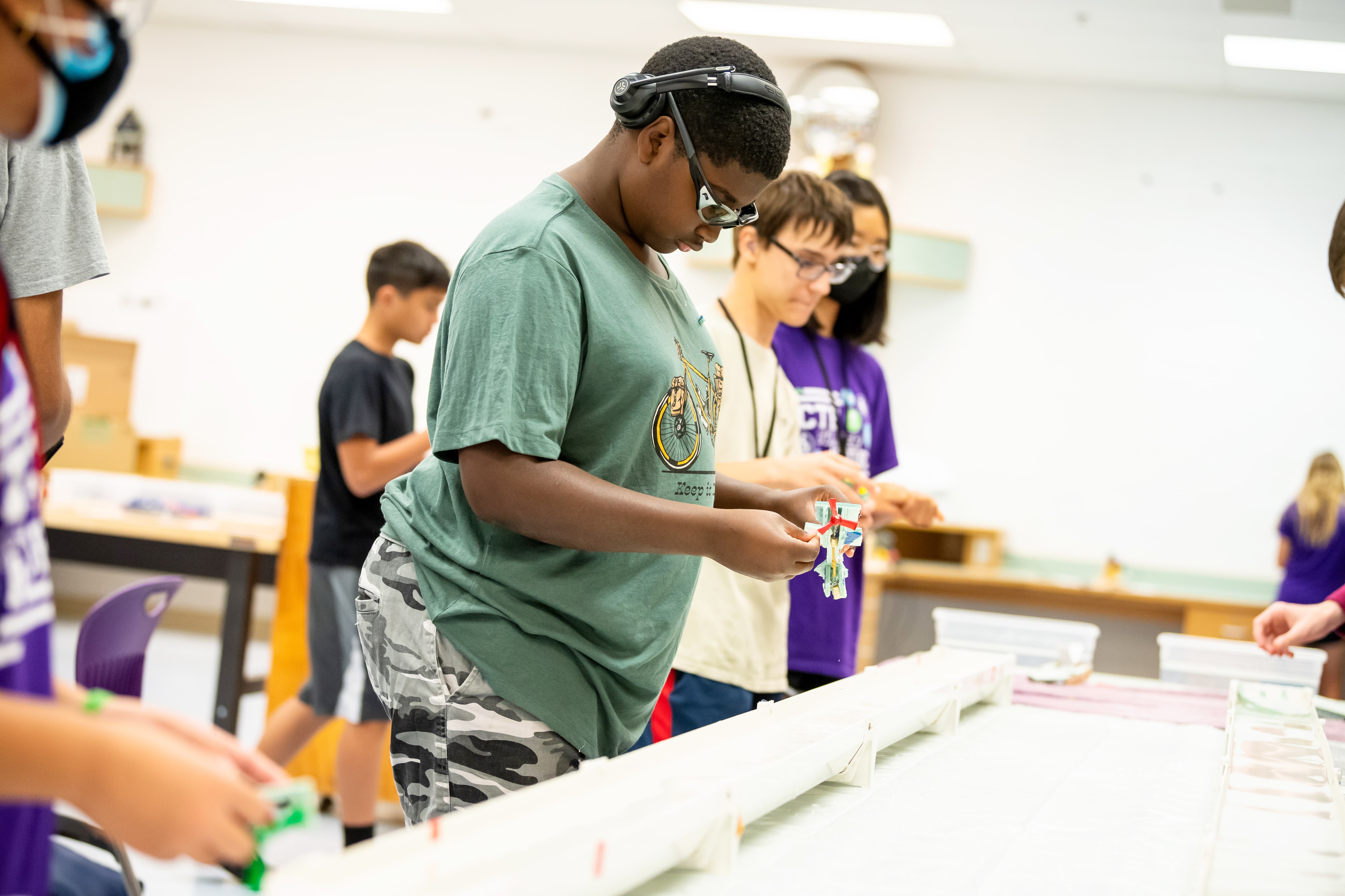 students building a boat during the summer academy