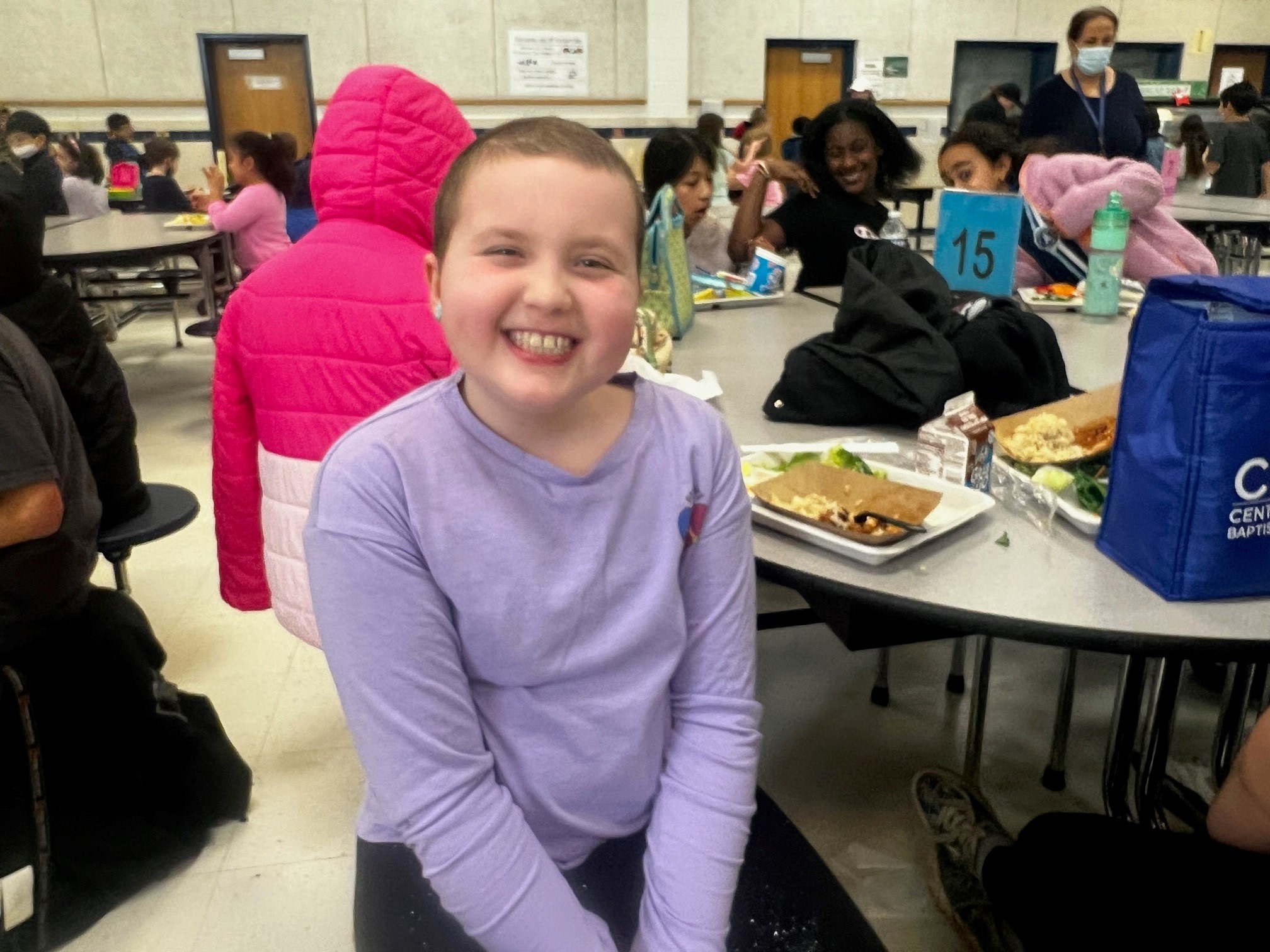 A student smiles in the cafeteria. 