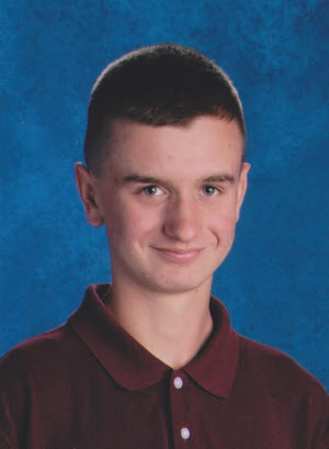 AT Ambassador Graduate, Andrew's school picture of him with wearing a maroon shirt with a blue background behind him.