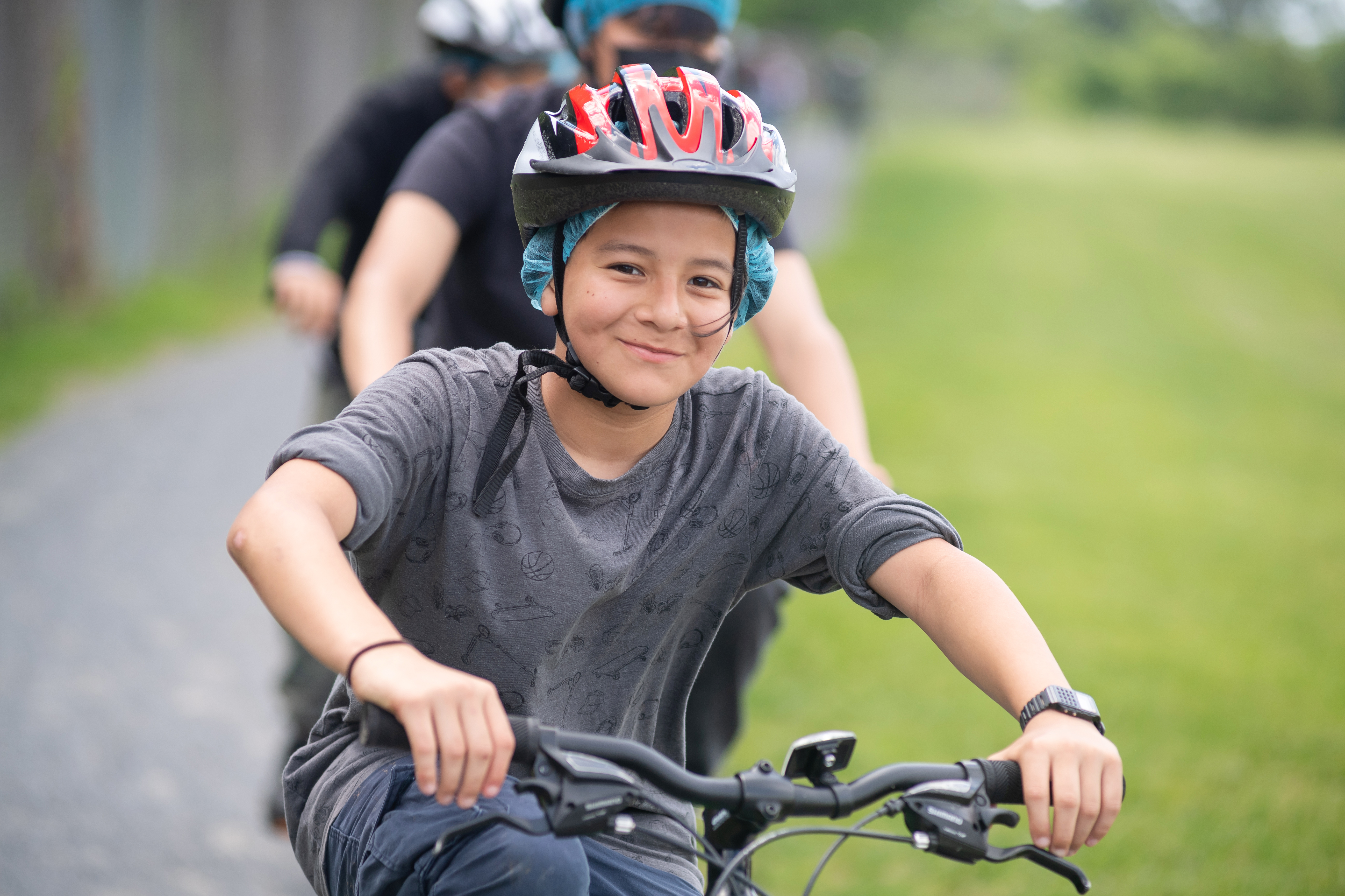 A Poe sixth-grader smiles while riding a bike in physical education class.