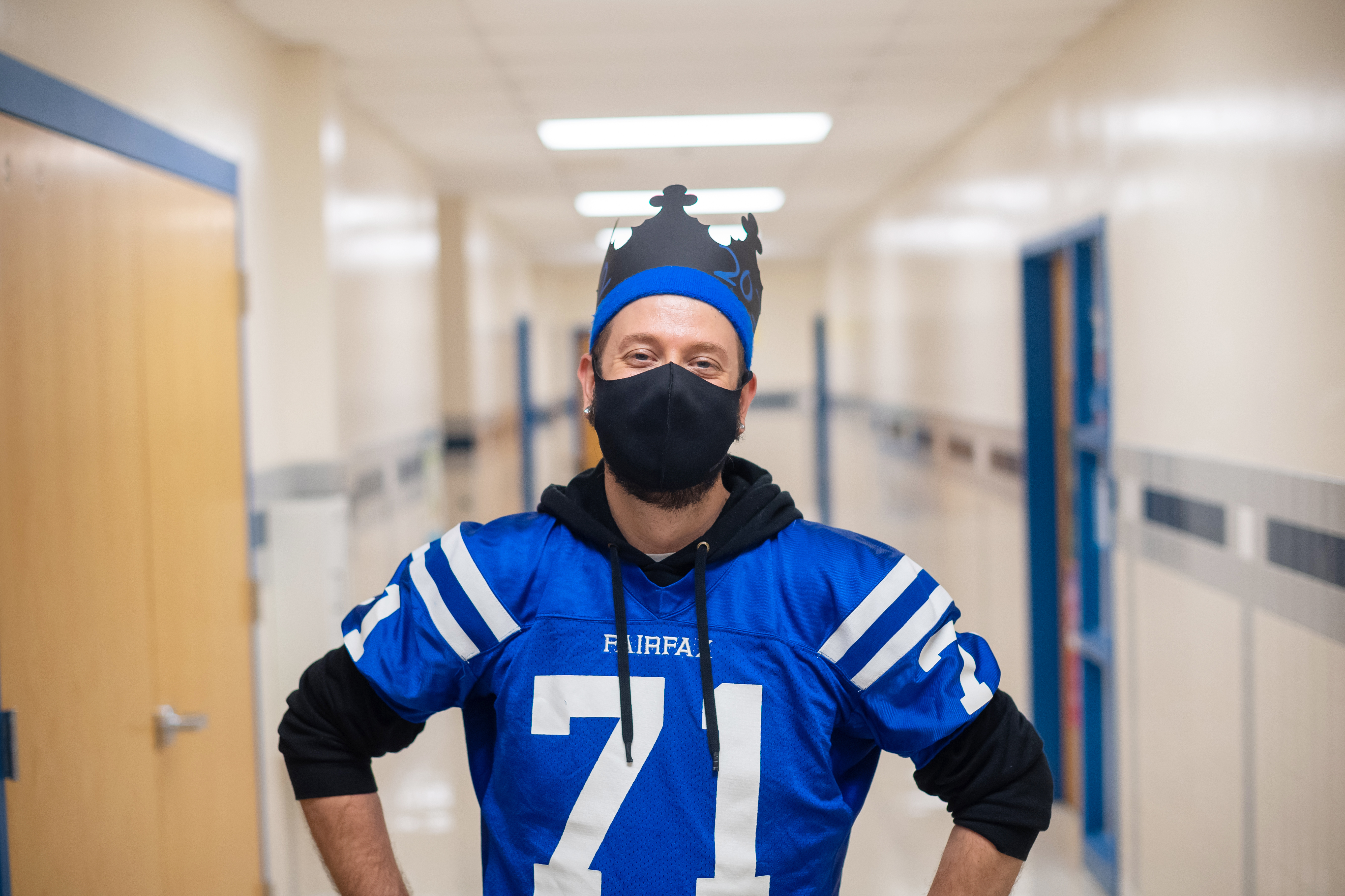 Fairfax eSports faculty adviser David Greene, a ninth grade English teacher by day, poses for a picture in a school jersey.
