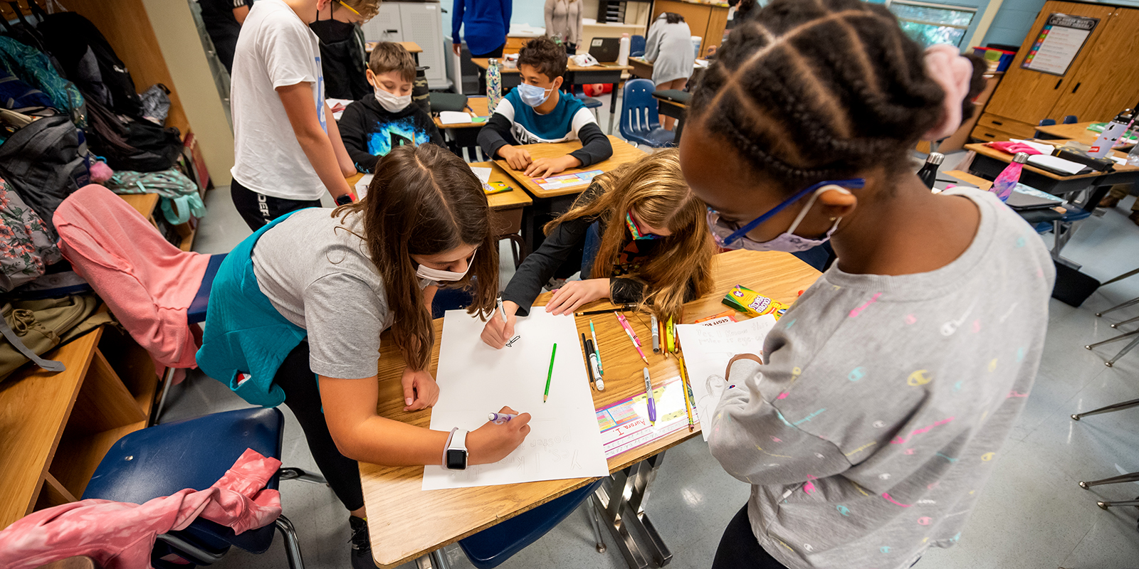 Sixth-graders at Franklin Sherman Elementary work on posters to promote safe habits during the Covid-19 pandemic.