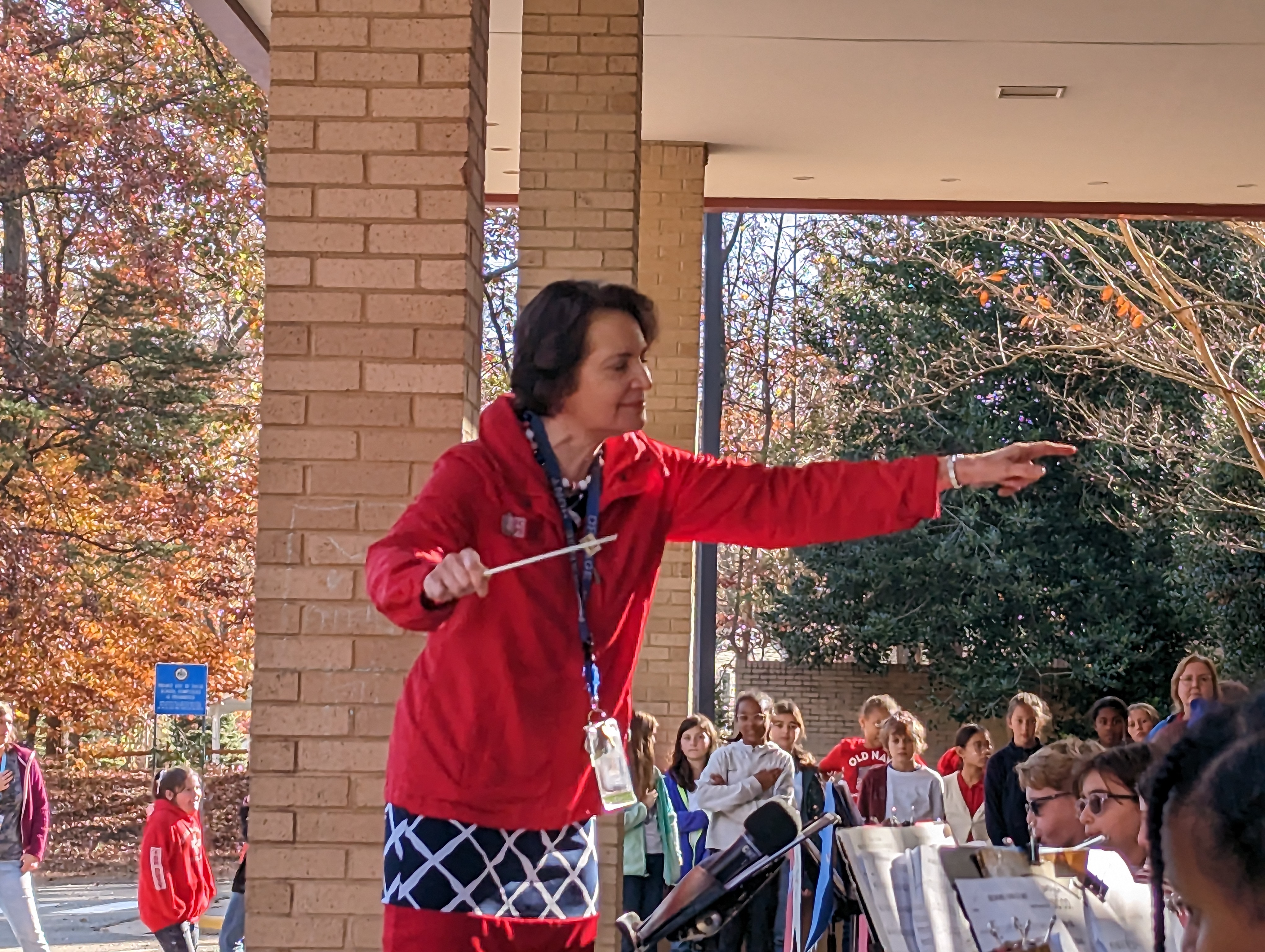 Orange Hunt Elementary band director Eileen Fraedrich leads students in performing a variety of patriotic songs.