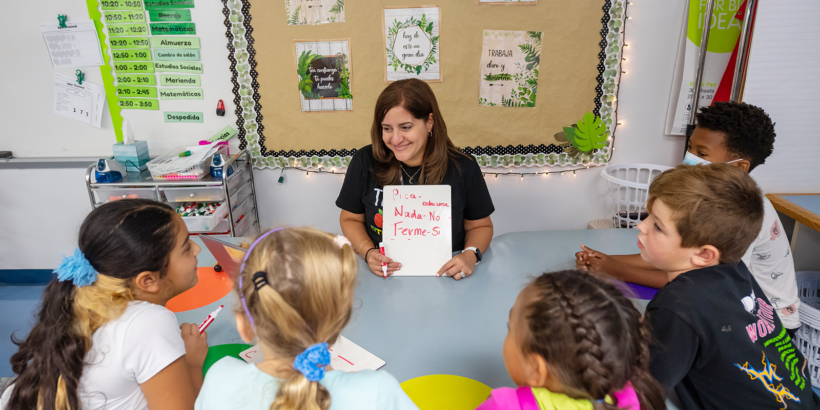 Lesliean Luna, a Spanish immersion teacher at Laurel Ridge Elementary, leads a small-group lesson with her third-grade students.