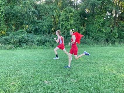 two high school boys running