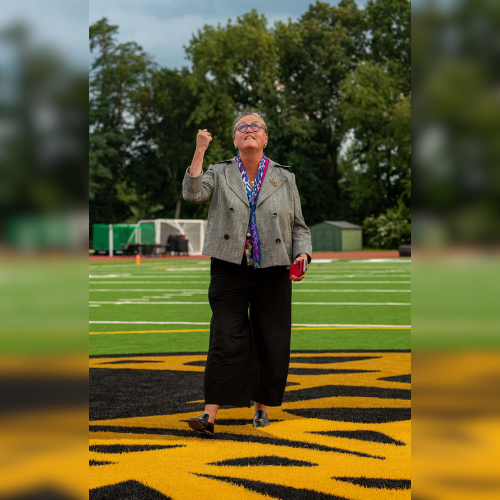 Dr. Reid tossing a coin at the Falls Church HS football field