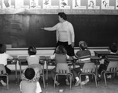 photo of teacher at blackboard 