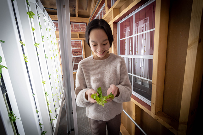 a girl holds lettuce