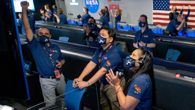 Swati Mohan (foreground) and fellow NASA mission control employees cheer as the Perseverance craft landed safely on Mars. Courtesy of NASA/JPL