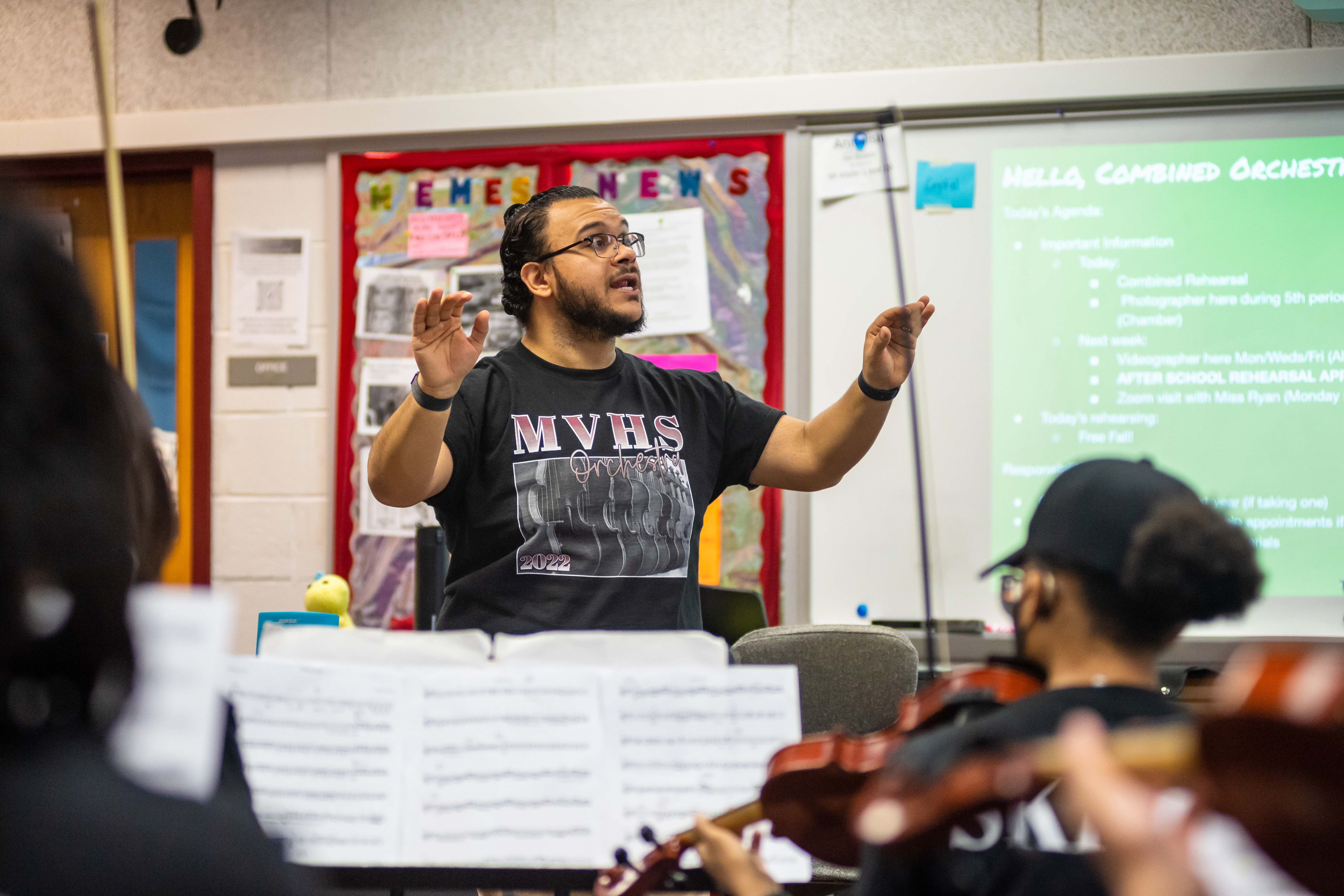 Orchestra teacher Alberto Rodriguez conducts a rehearsal.