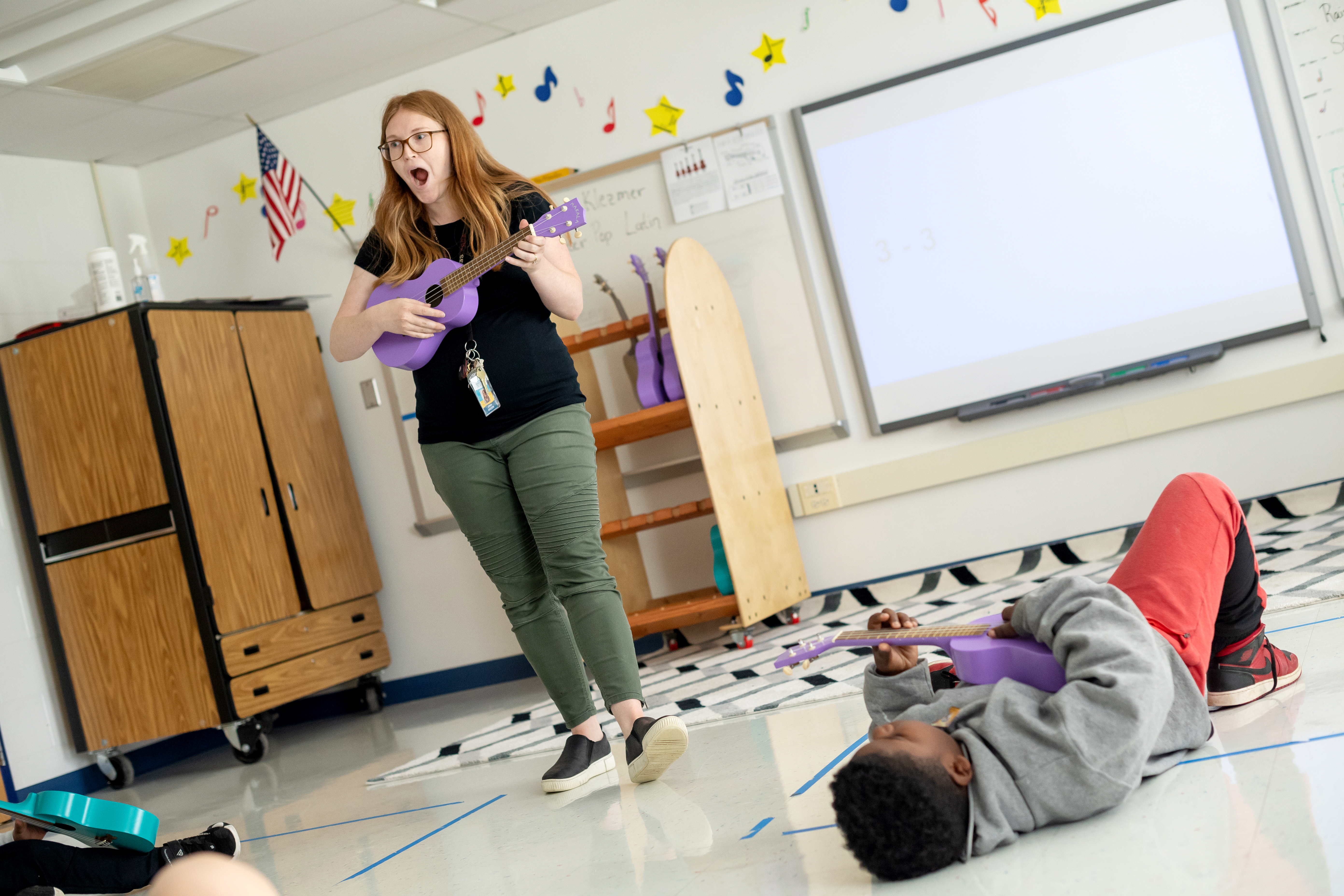 Music therapy teacher Jenna Grazzini helps students write a song. 