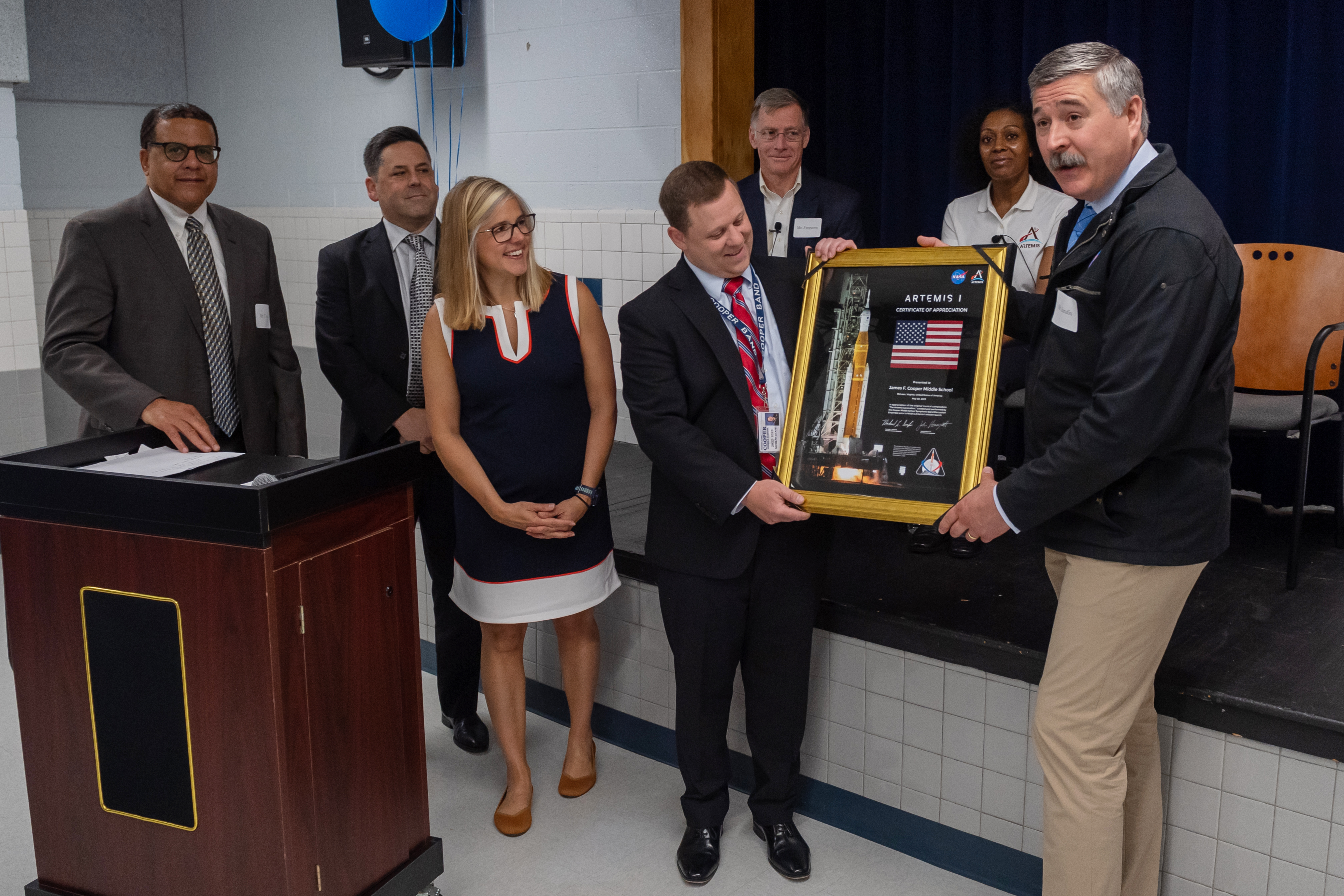 School administrators being presented with a plaque from NASA guests. 