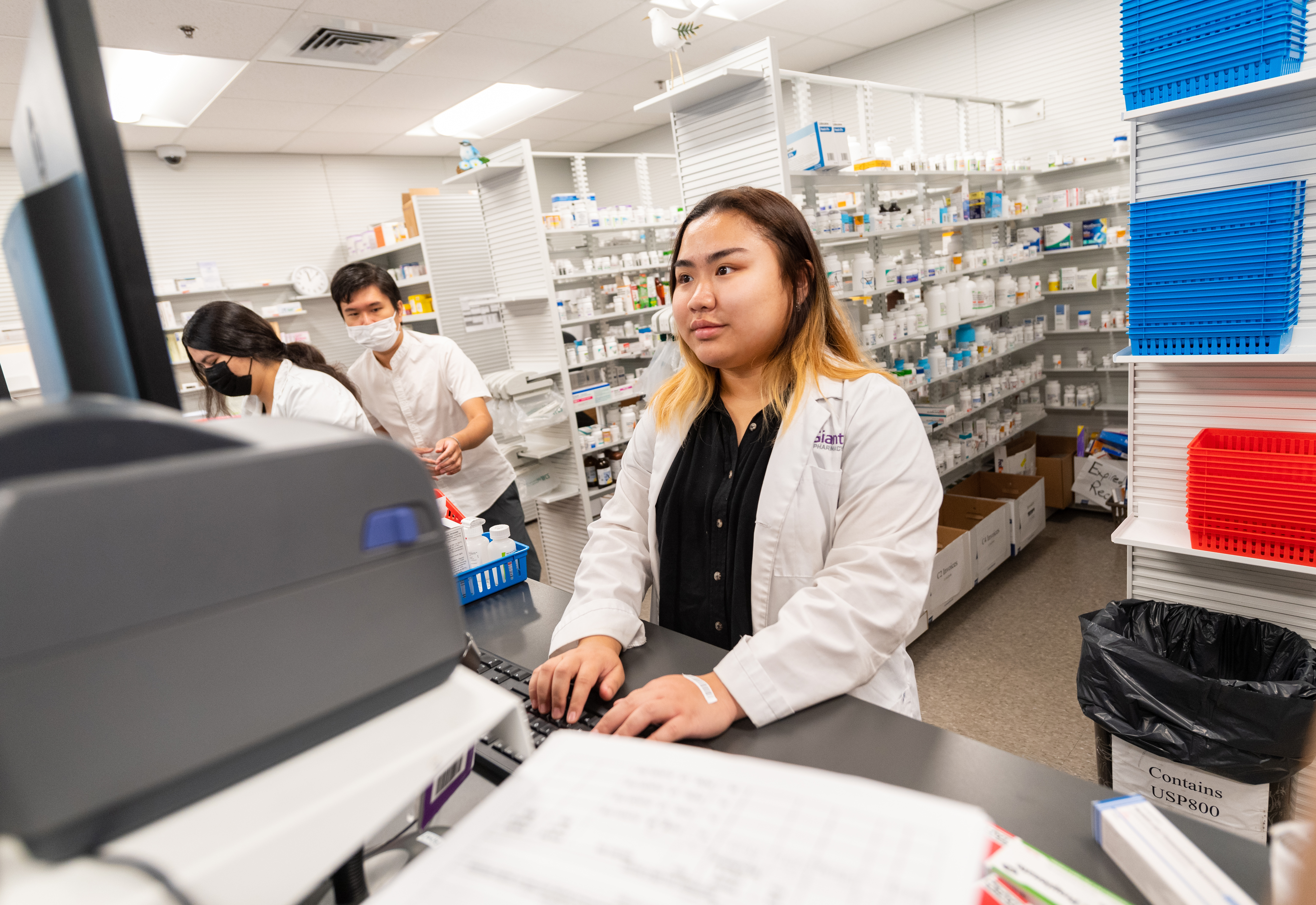 Lam To working as a pharmacy technician. 
