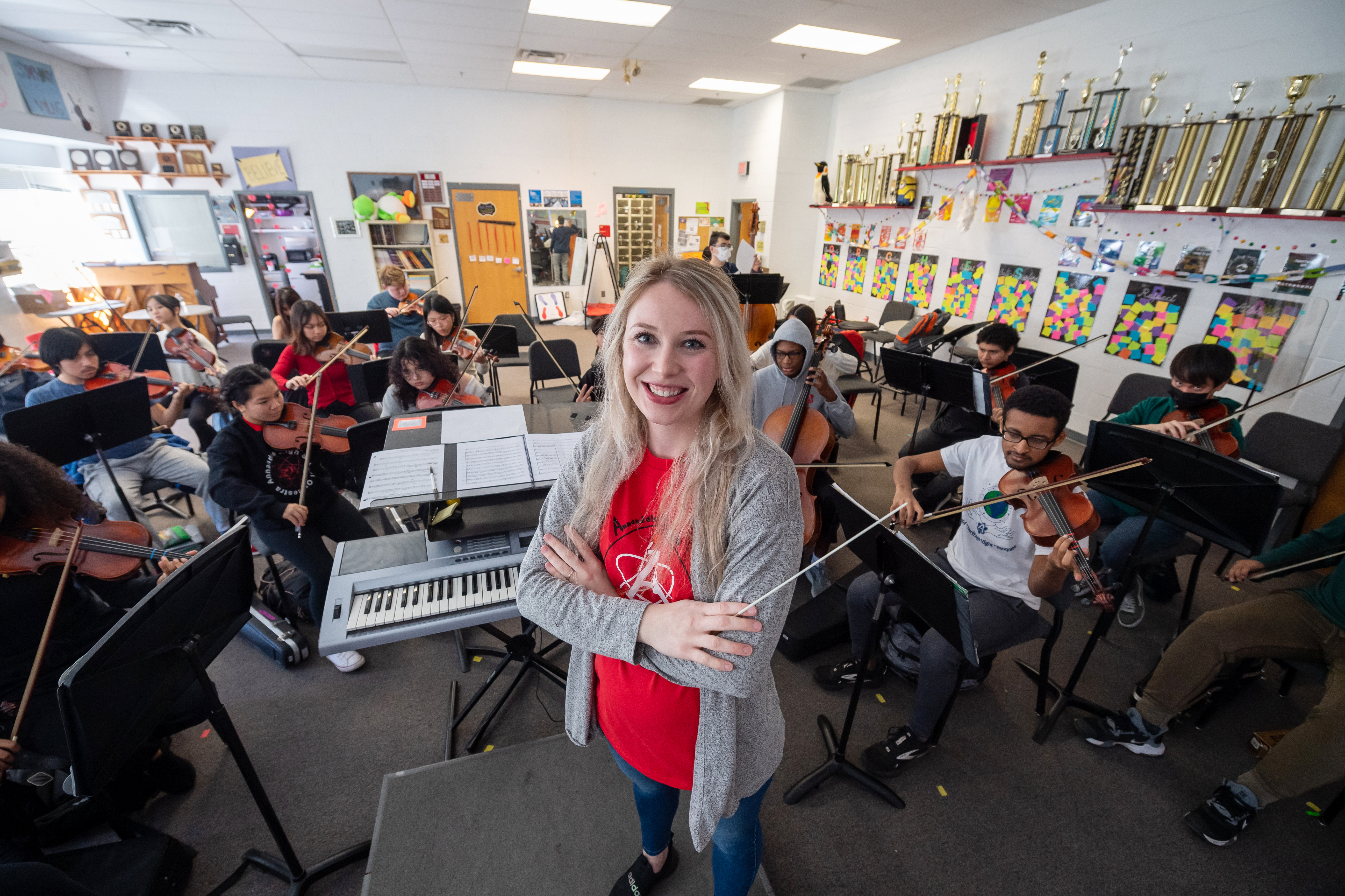 Annandale High School Orchestra Director Annie Ray poses for the camera as her students rehearse.
