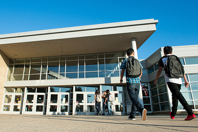 students walking into a school building
