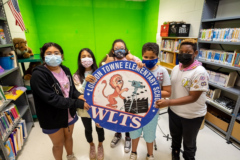 The WLTS news team with their logo. 