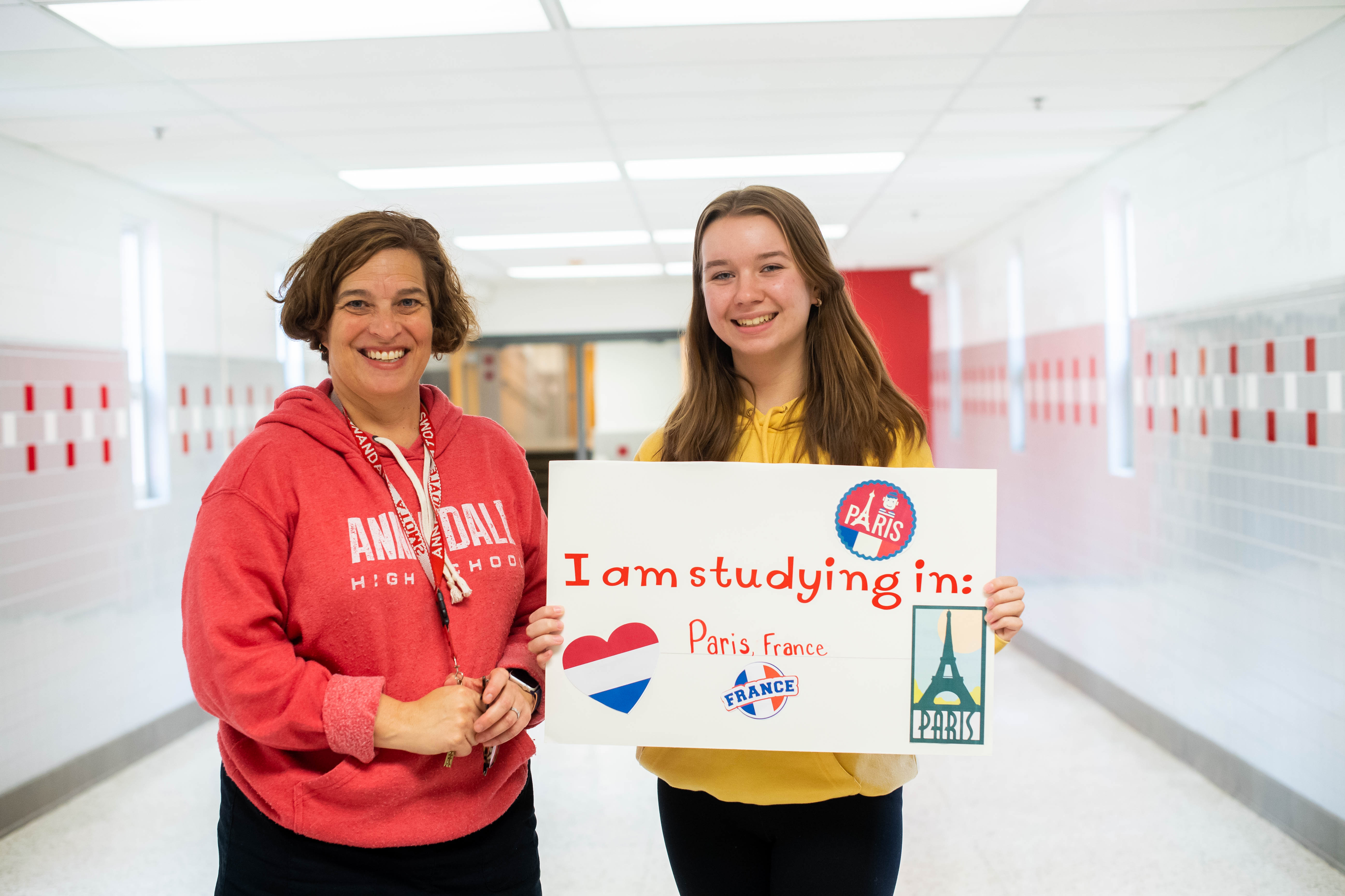 Meredith Hedrick, Annandale's English for Speakers of Other Languages department chairwoman, stands with a student headed for Paris this summer.