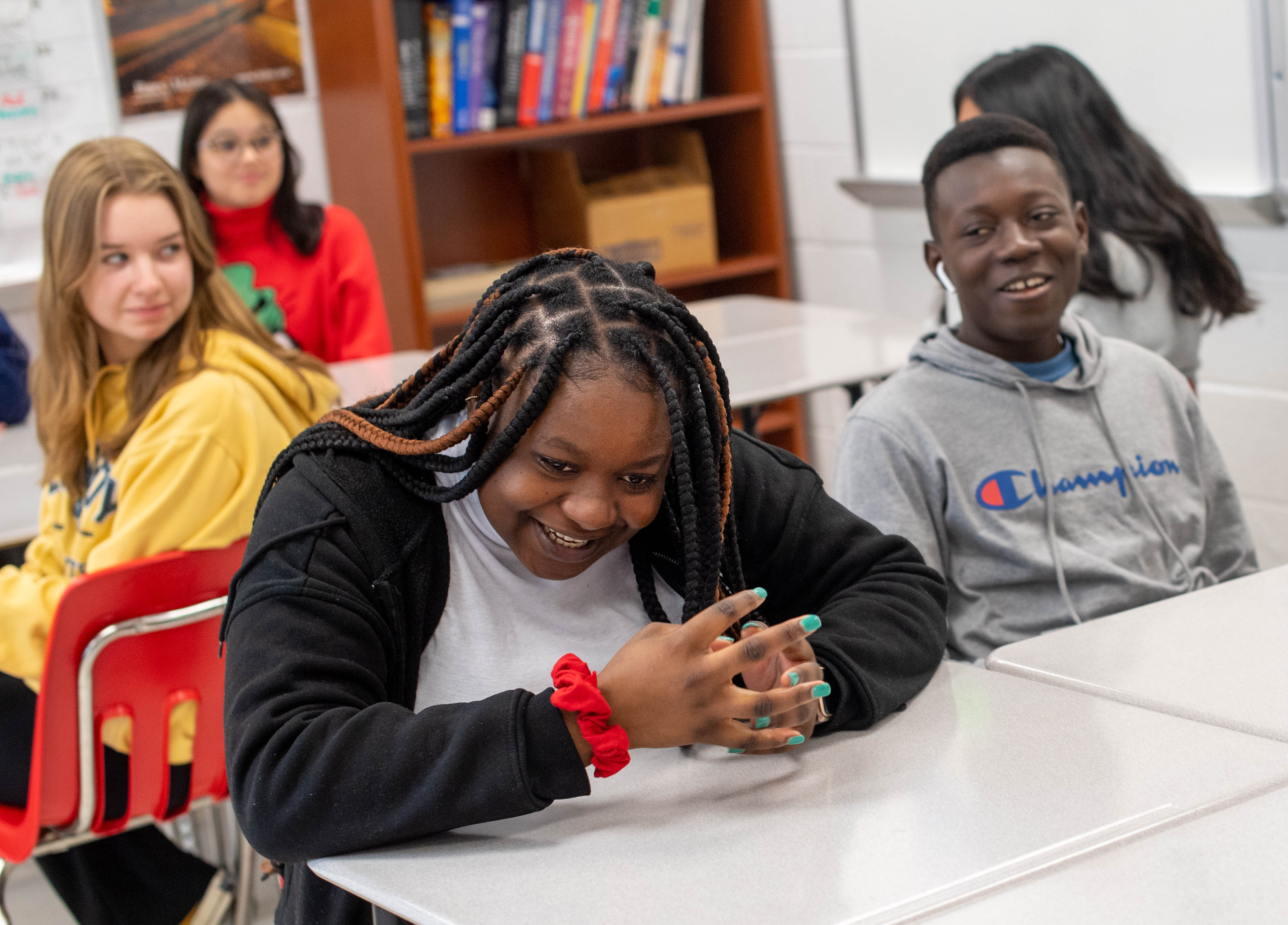 Annandale High School study abroad scholarship winners laugh and share goals during a meeting about summer program plans.