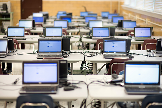 classroom full of laptops on tables