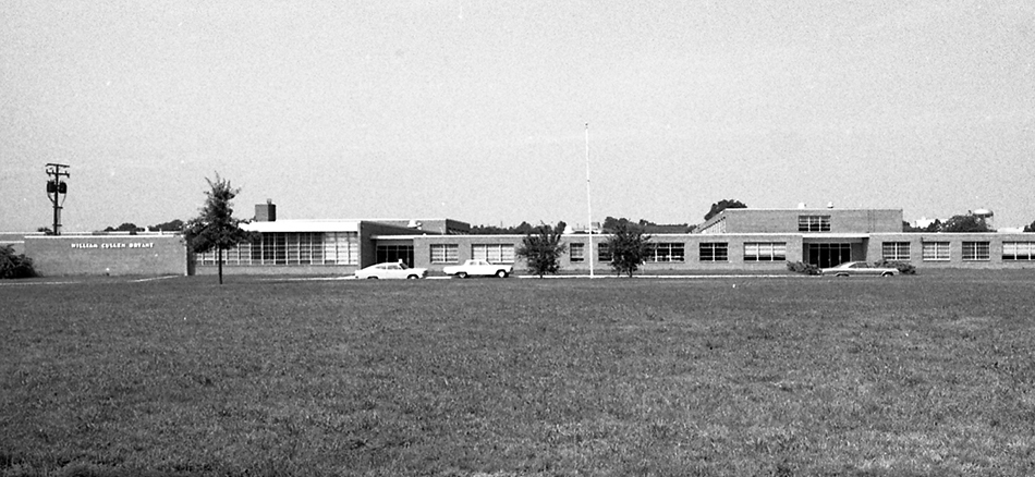 Black and white photograph of Bryant Intermediate School. The photograph was taken from a vantage point along Quander Road and shows the full length of the front of the building.