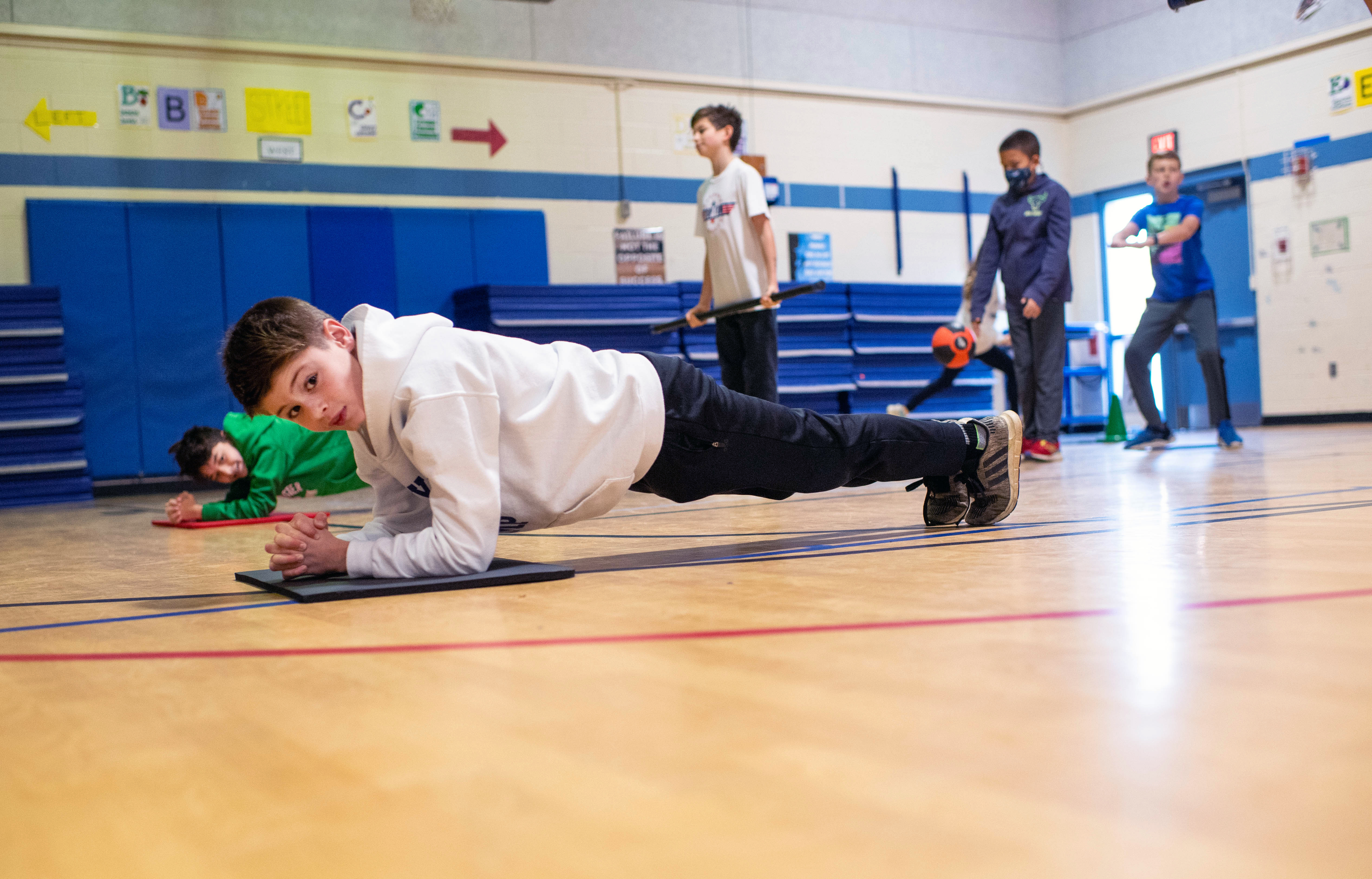 A student holds a plank pose during a Fitness Warrior morning workout at Chesterbrook Elementary in McLean, Va.