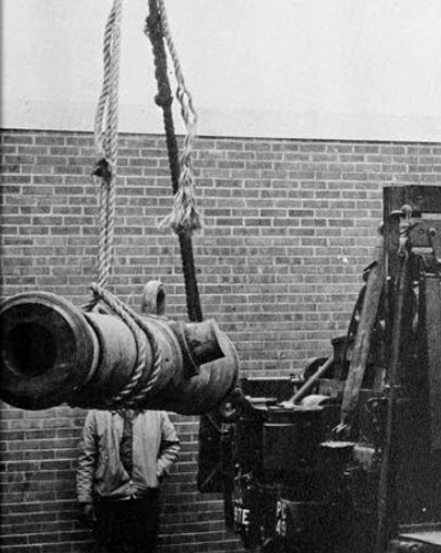 Yearbook photograph of a cannon being lowered into place.