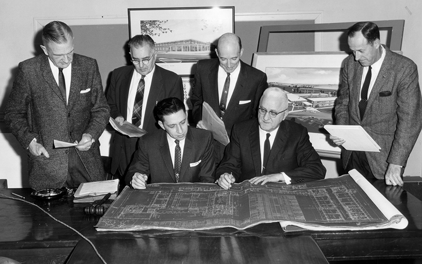 Black and white photograph of Superintendent Woodson with School Board members.