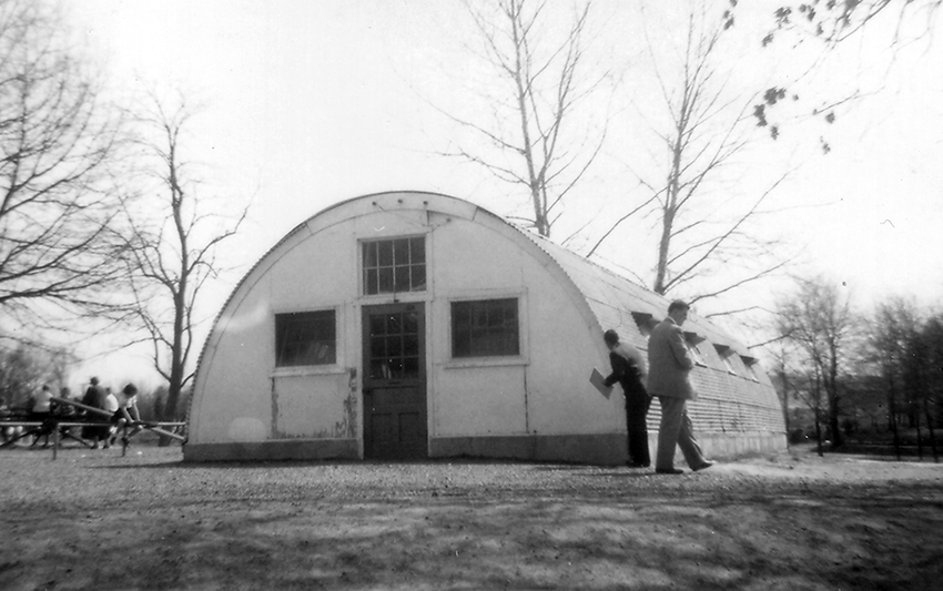 Black and white photograph of a Quonset hut on the grounds of Fairfax Elementary School.