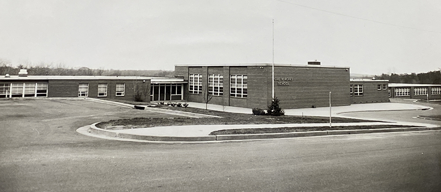 Black and white photograph of the front exterior of Green Acres Elementary School.