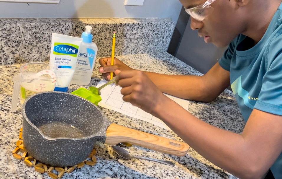 Woodson freshman Heman Bekele experiments with different combinations of products to develop his skin cancer treatment soap.