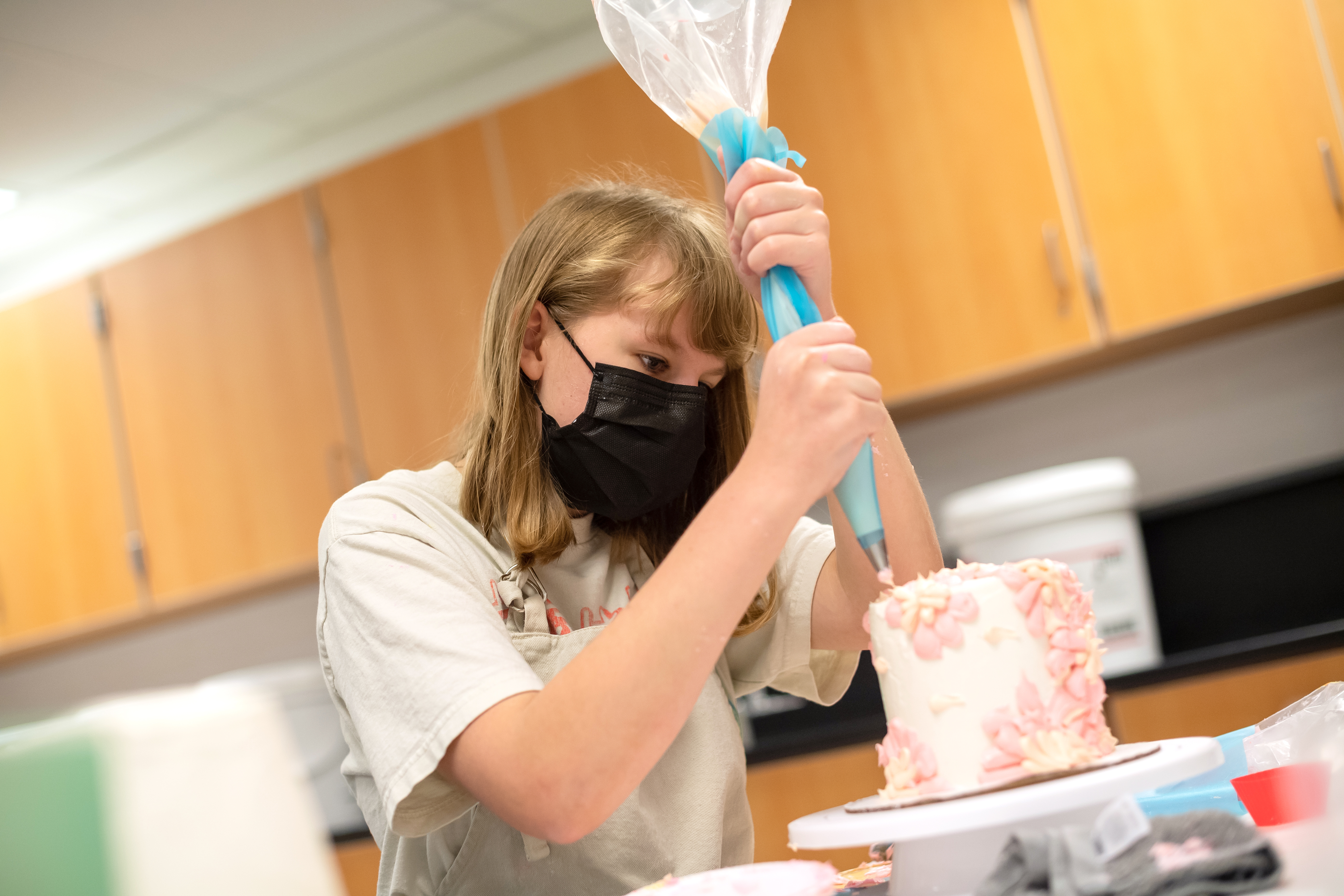 Ally Boylan, a rising Woodson HS sophomore, practices icing piping techniques during an FCPS summer program at Lake Braddock Secondary School.