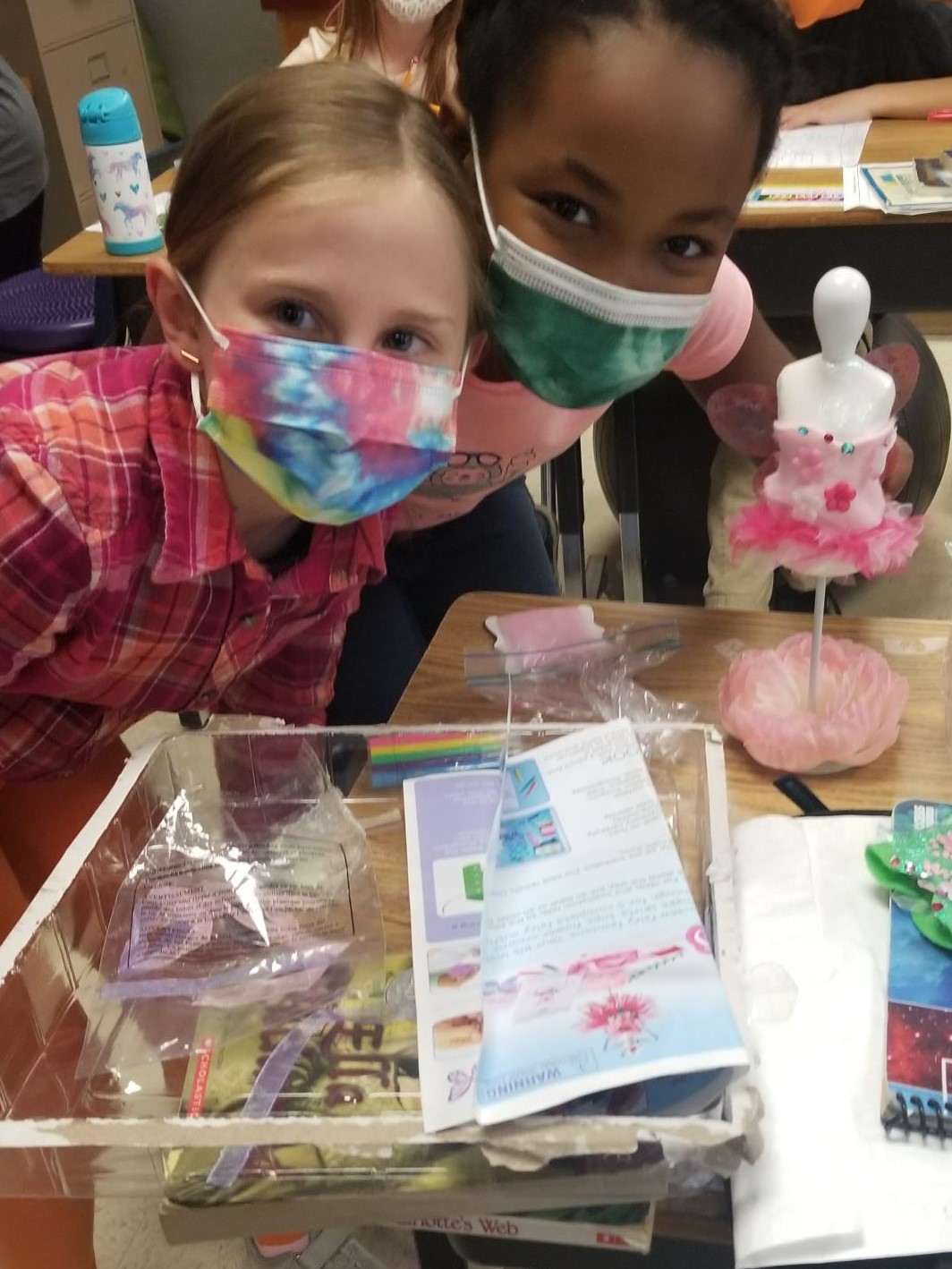 Two Wakefield Forest third-graders design fairy clothes on a fashion bust during Innovation Hour.  ​