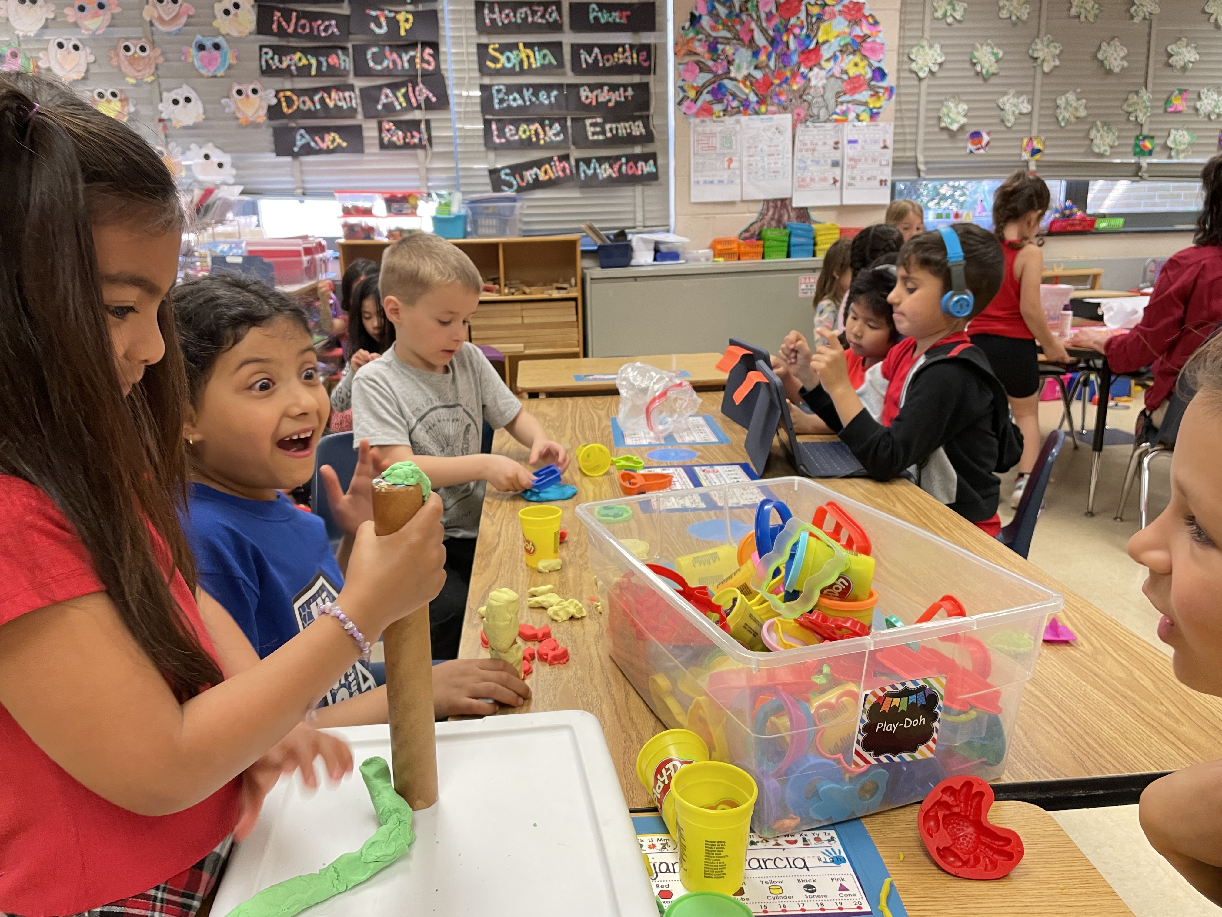 Young students play with modeling clay