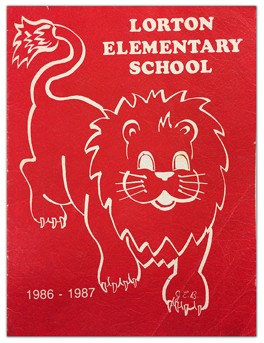 Photograph of a Lorton Elementary School yearbook cover. The cover is red and features an illustration of a lion.