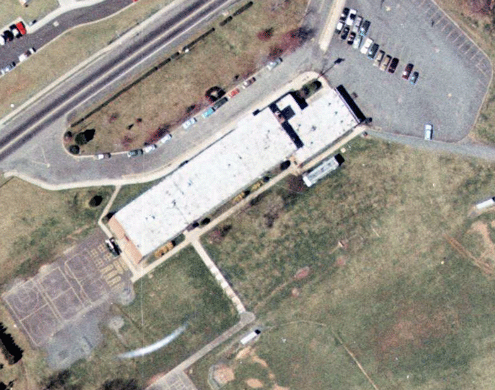 Animation which fades back and forth between an aerial photograph of Layton Hall Elementary School in 1976 and Daniels Run Elementary School in 2009.