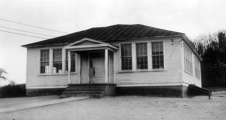 Black and white photograph of the old Lorton School. It is a four-room wood-framed building.