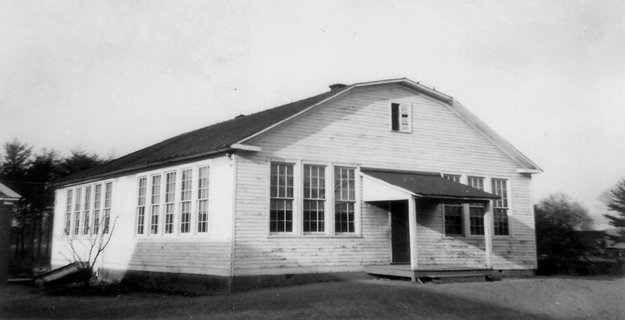 Black and white photograph of the old Lorton School. It is a four-room wood-framed building.