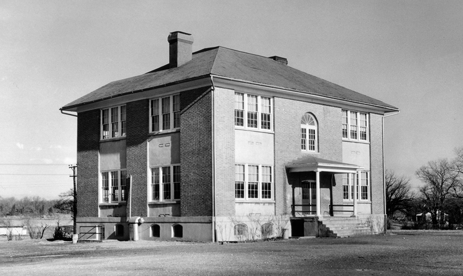 Black and white photograph of the old Bailey’s Elementary School. It is a two-story brick and wood-frame building.