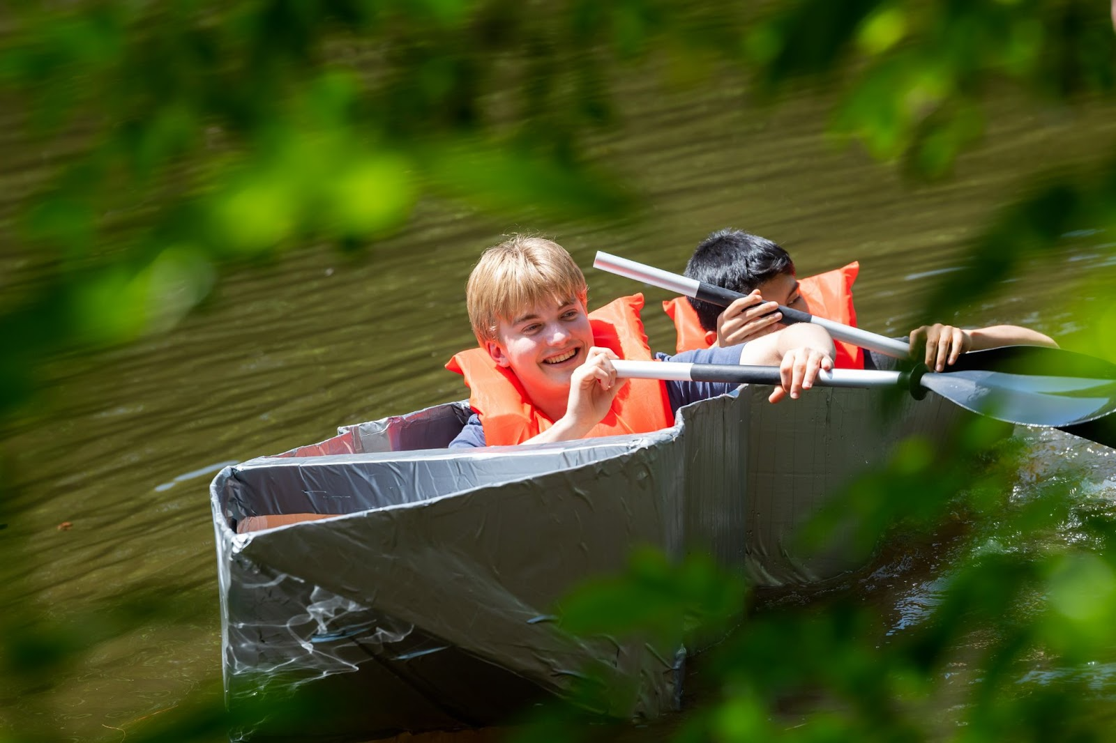 students in cardboard boat