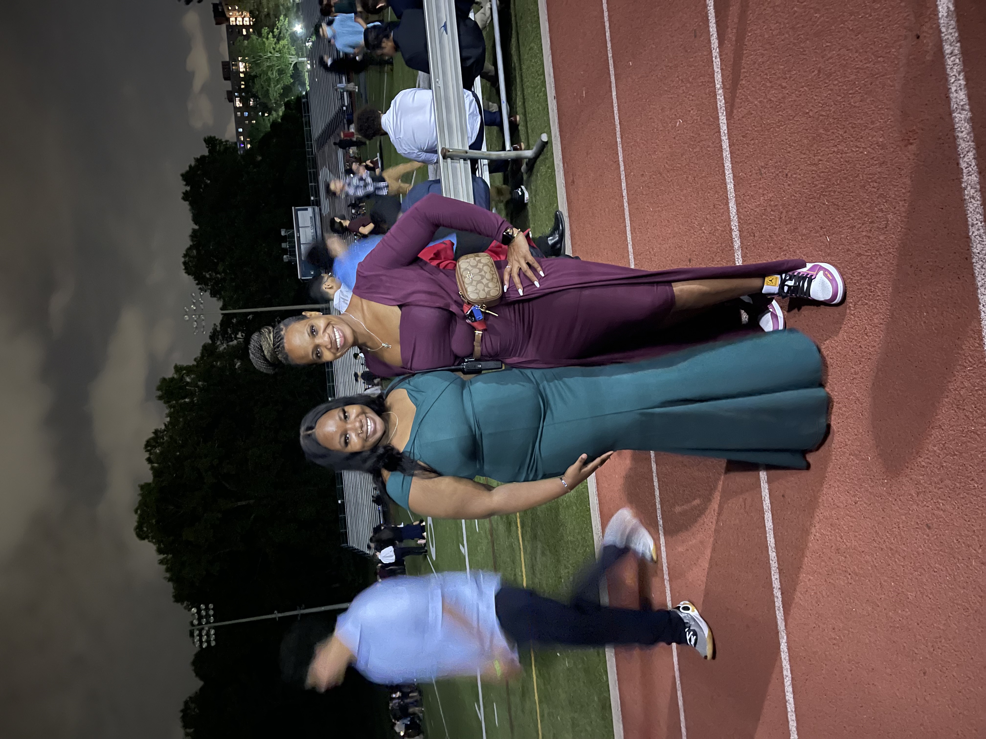 Justice High Principal Tiffany Narcisse and her daughter, senior Dori Bob, get ready to dance on the track field during the school's Oct. 9 Homecoming dance.