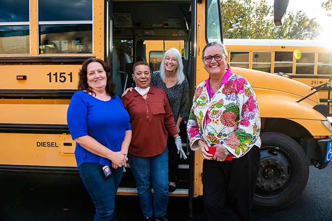 Dr. Reid with three bus drivers