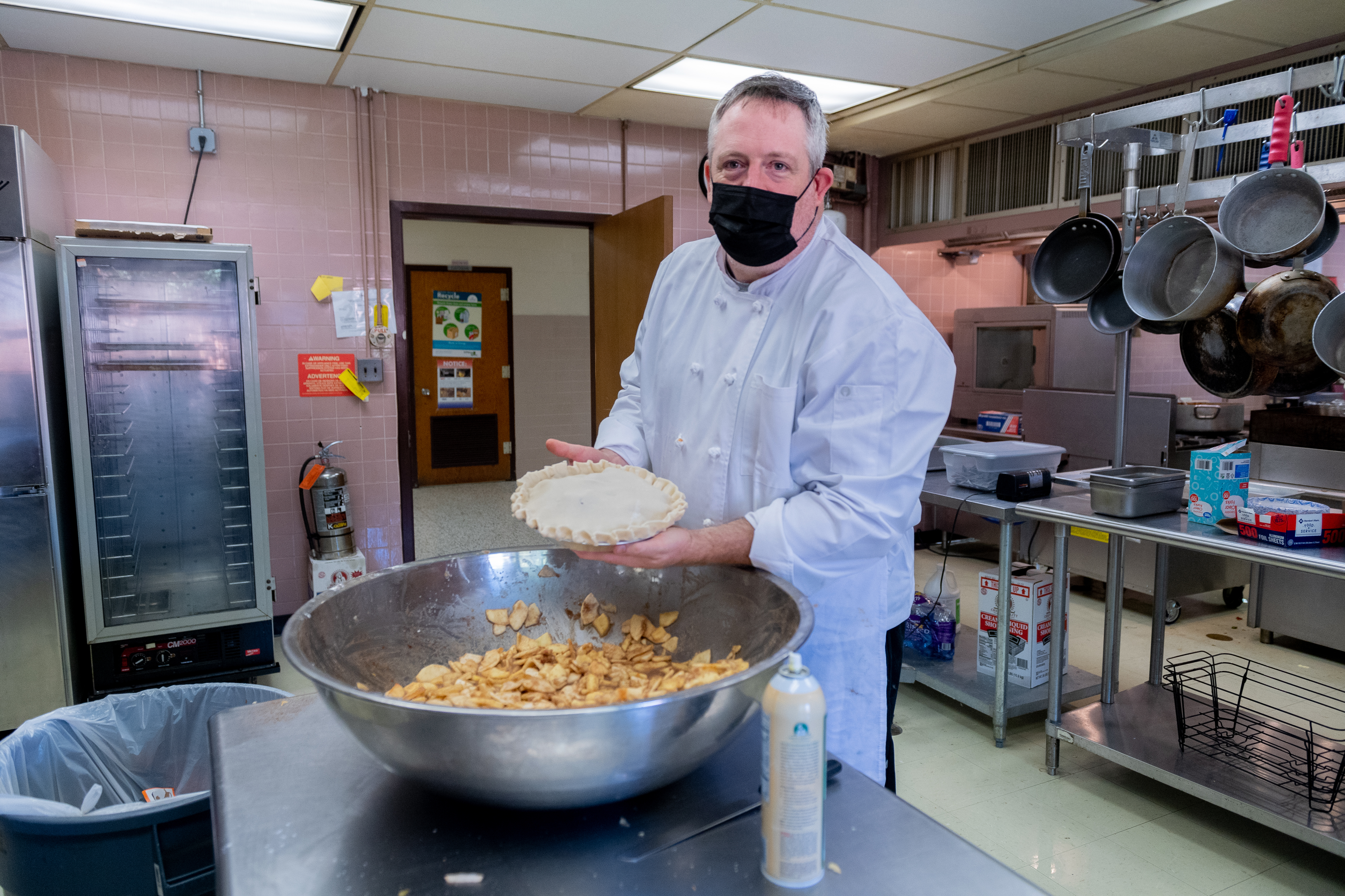 Culinary Arts teacher Dustin Payne shows off the beginning of an apple pie.