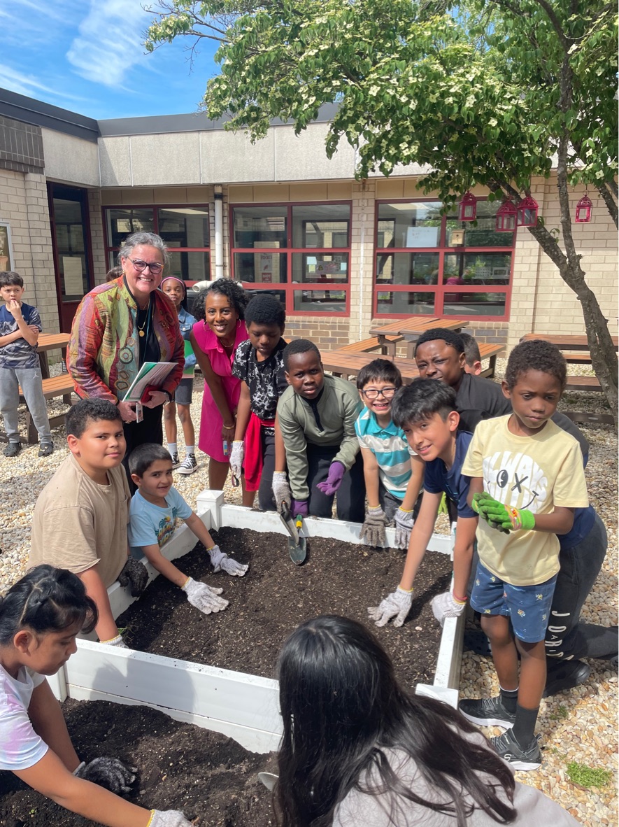 Dr. Reid with staff and students at Riverside ES's Love and Health Garden