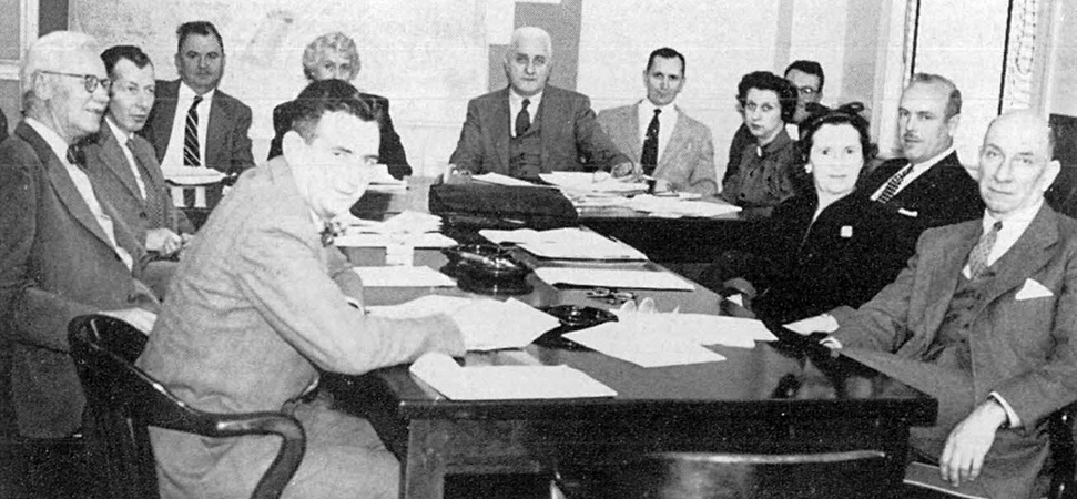 Black and white photograph of a School Board meeting.