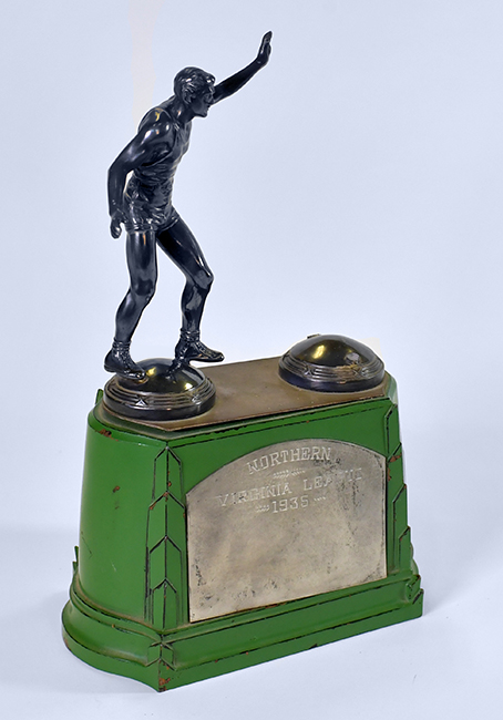Photograph of a basketball trophy. It has a green base with text that reads: Northern Virginia League, 1935.