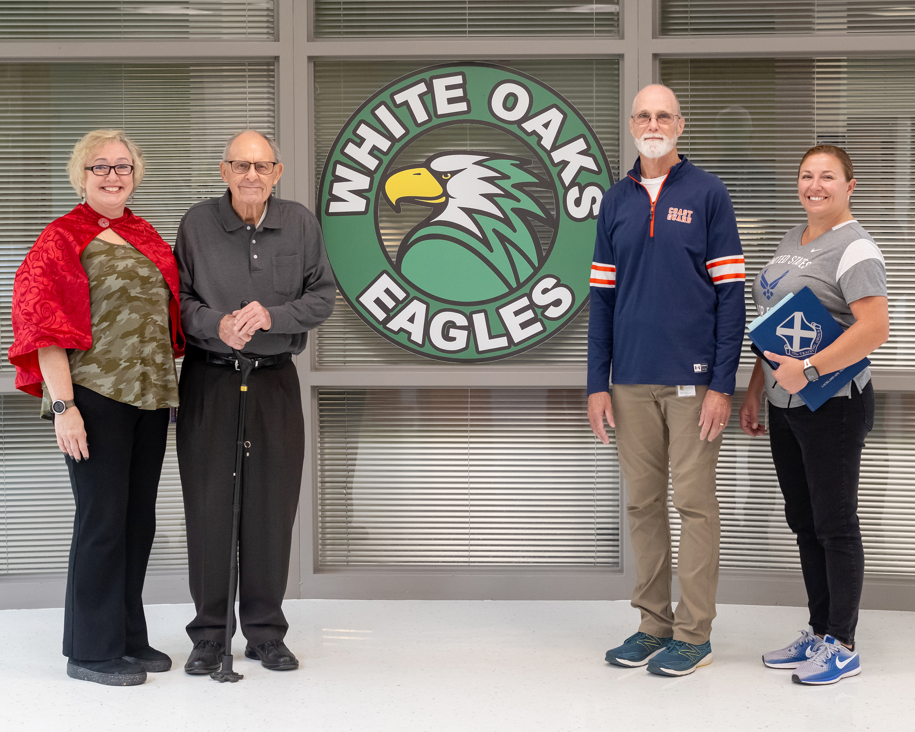 From left: Sgt. DiBacco, Capt. Stuntz, Capt. Peek, and MSgt. Pruismann stand in front of the White Oaks Elementary School logo.