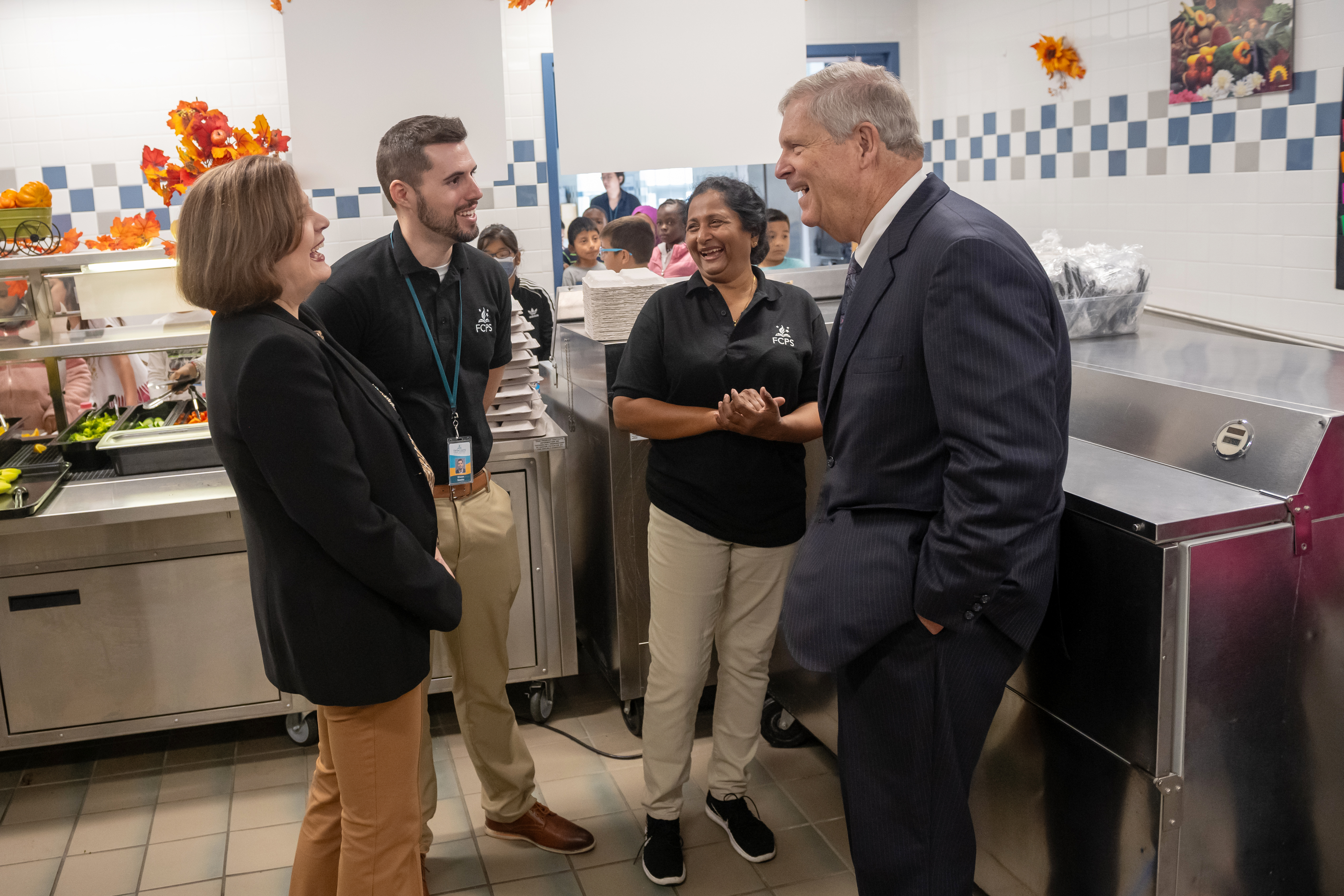USDA Sec. Tom Vilsack meets Annandale Terrace's cafeteria manager Rama Gundapaneni and FCPS Food and Nutrition Services executive director Shaun Sawko.