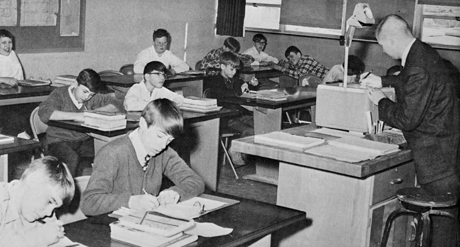 Black and white photograph showing students in a classroom.